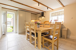 Barn End Cottage - dining area with patio doors to garden